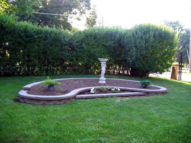 A garden with a bird bath in the middle of it