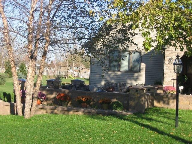 A house with a fence and pumpkins in front of it