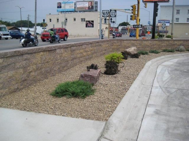A man is riding a motorcycle in front of a sign for route 66