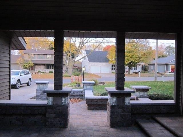 A white suv is parked in the driveway of a house