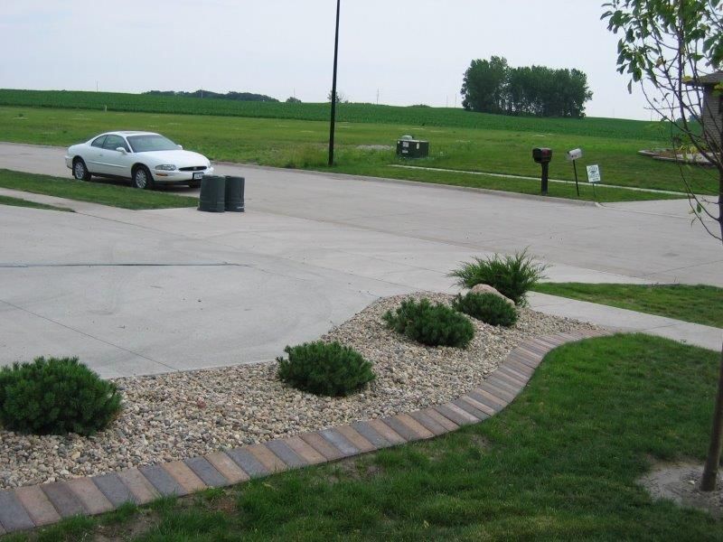 A white car is parked on the side of the road