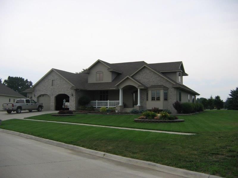 A large house with a truck parked in front of it