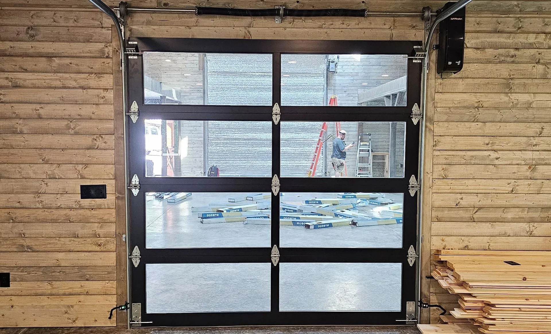 A garage door with a lot of windows and a wooden wall