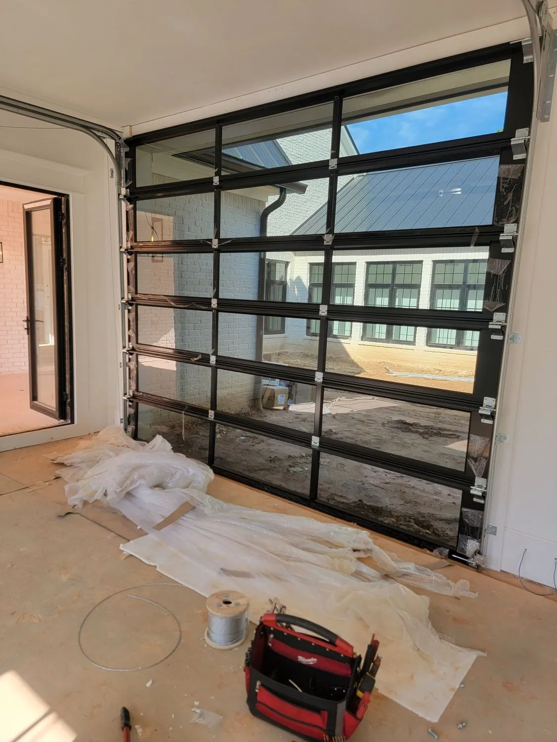 A garage door is being installed in a house.