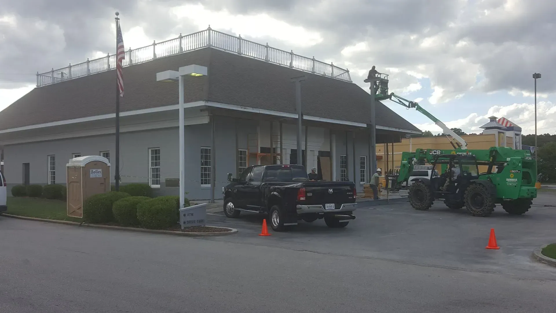 Exterior of a bank undergoing renovations. A truck and heavy equipment are present.