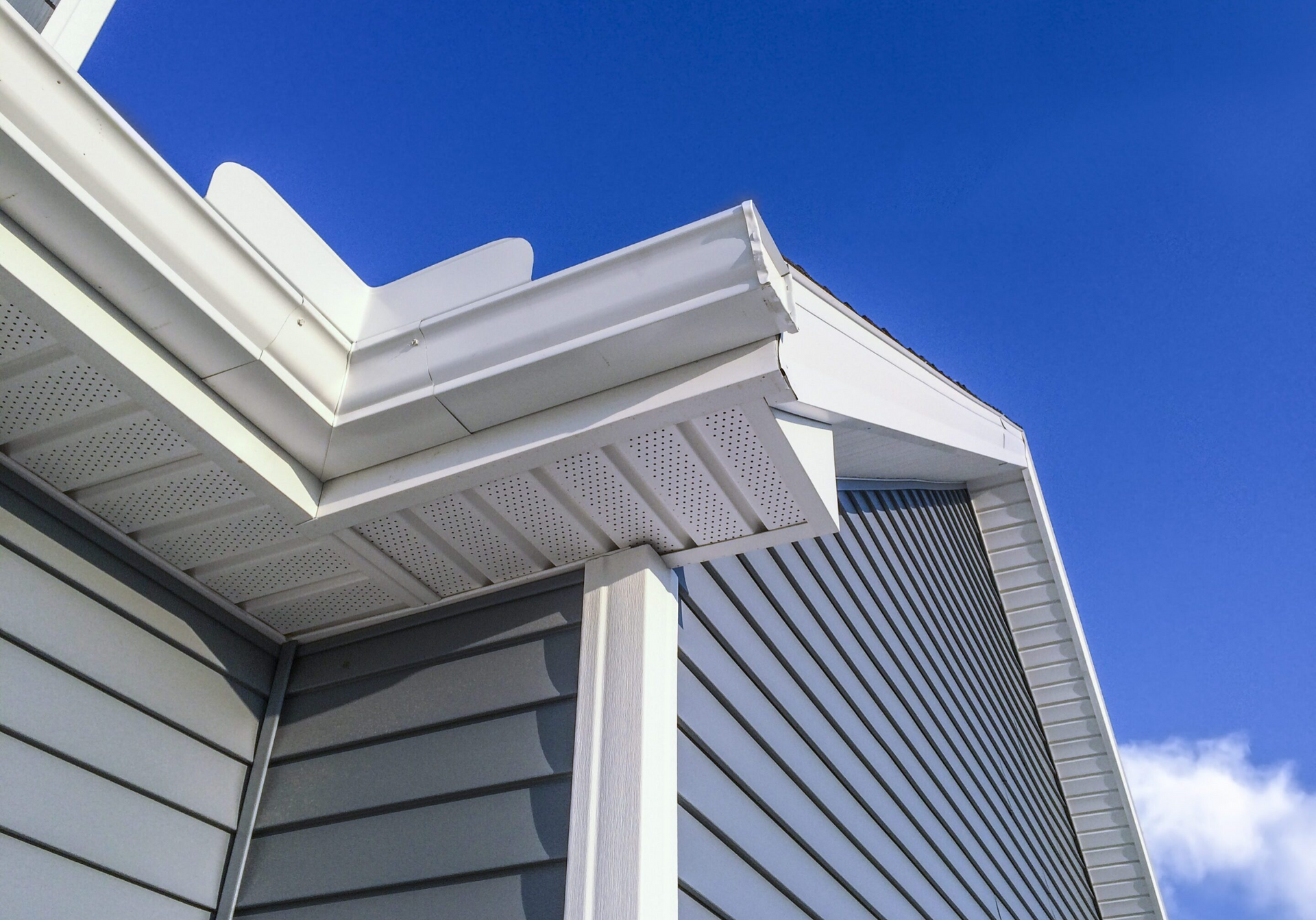 The roof of a house with a blue sky in the background