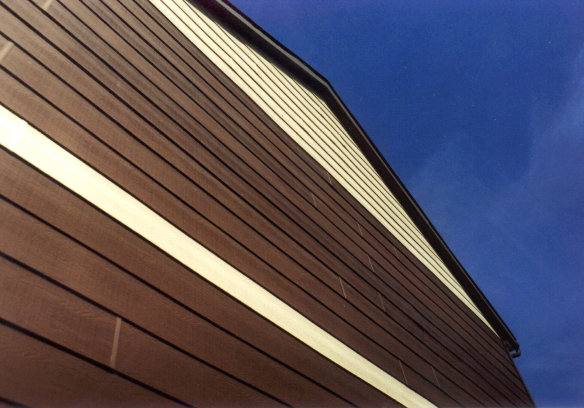Looking up at the side of a building with a blue sky in the background