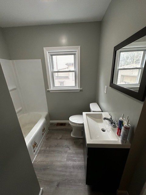 A bathroom with a sink, toilet, bathtub and mirror.