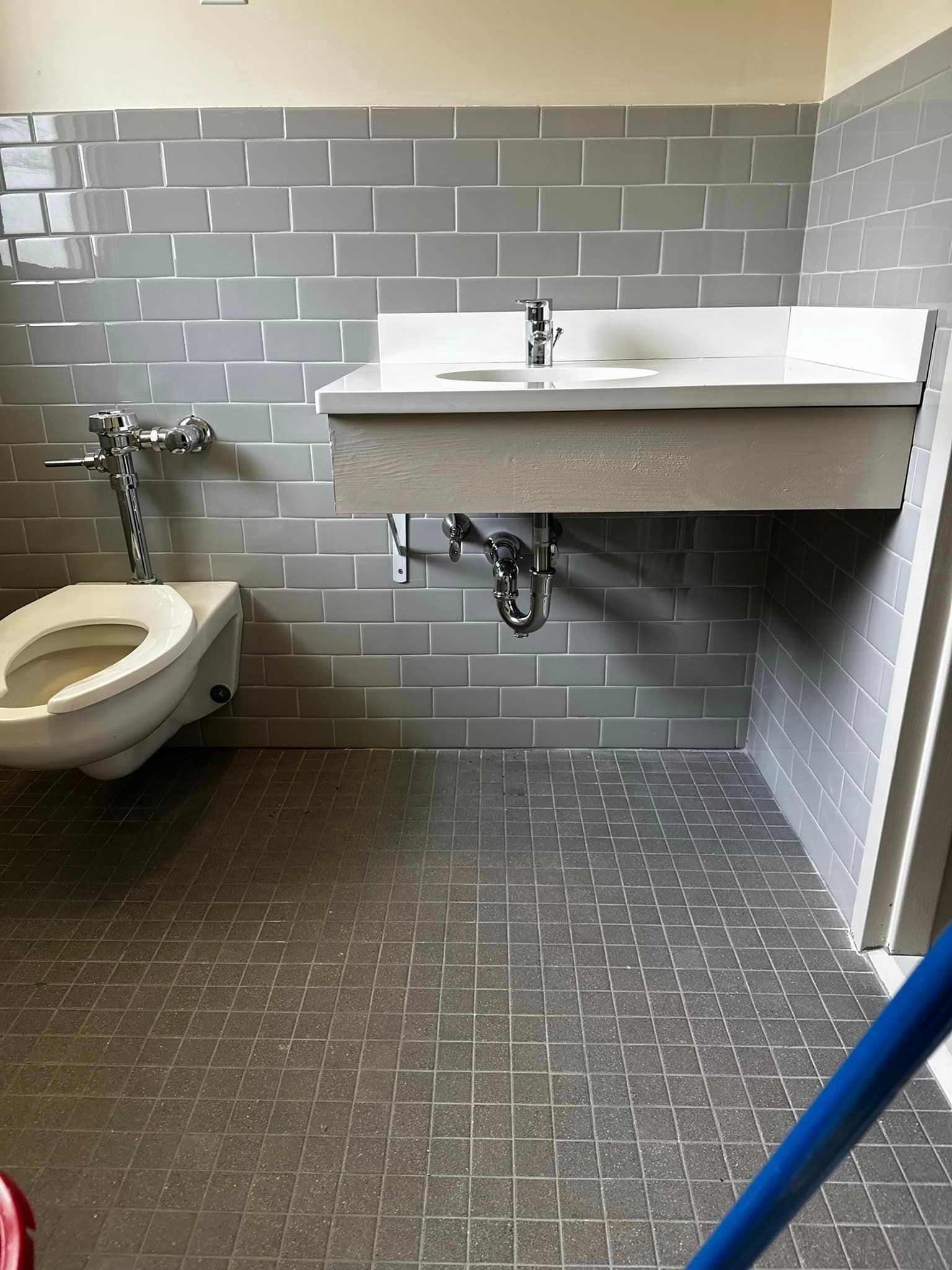 There is a toilet and a sink in the bathroom.