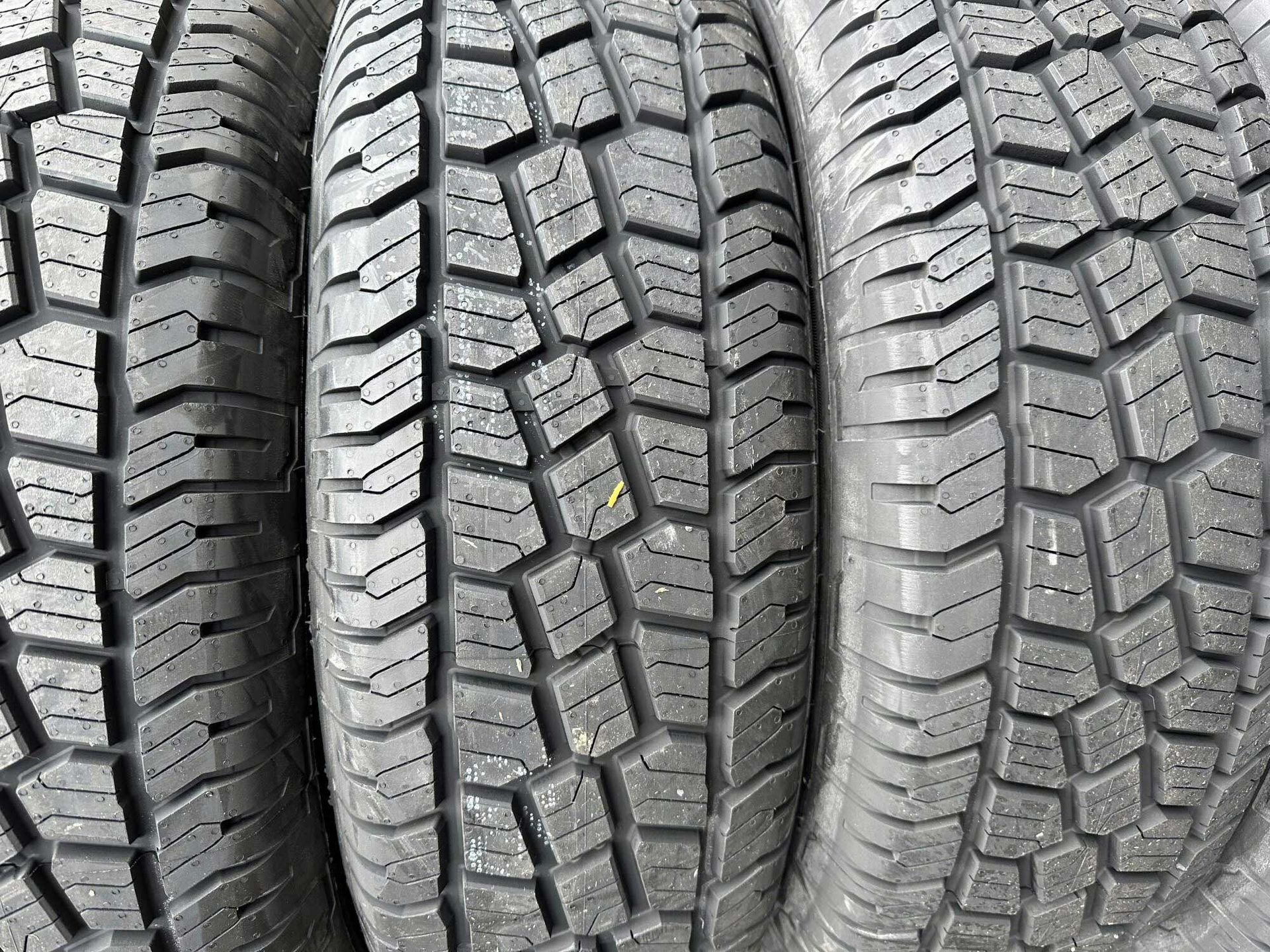 Three black tires with tread patterns arranged side-by-side.