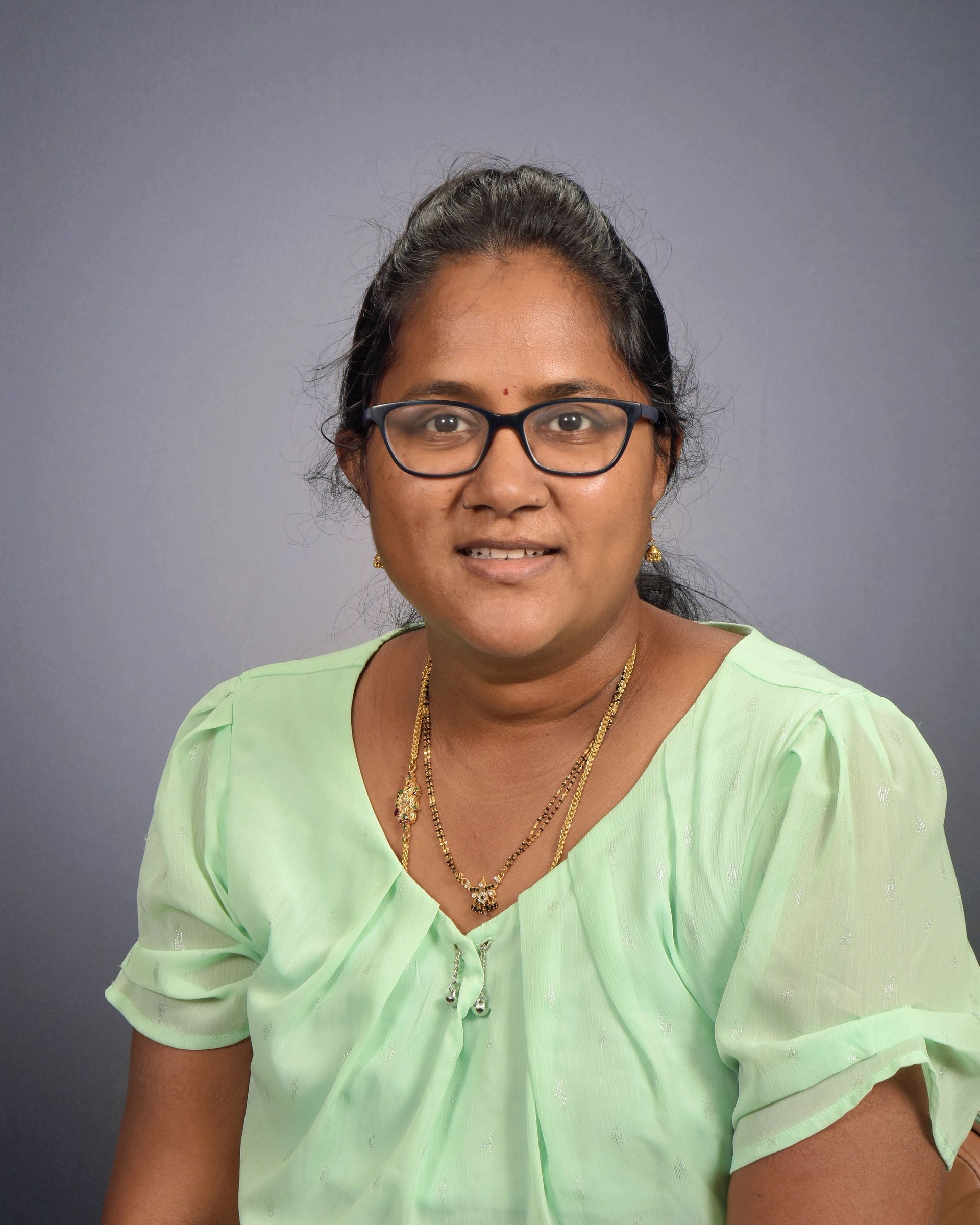 A silhouette of a woman without a face on a gray background.