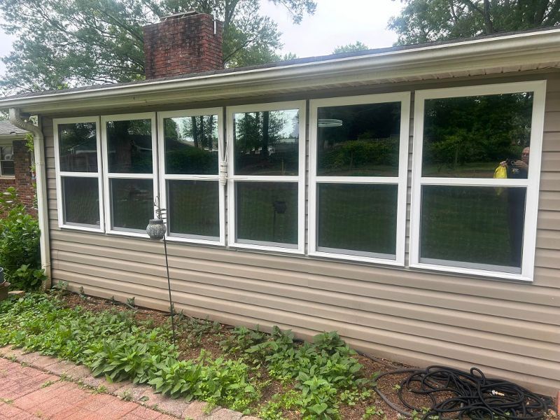 A house with a lot of windows on the side of it.