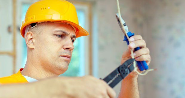 Repairman repairing a residential electrical wiring