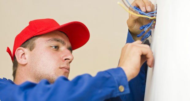 Repairman repairing an electrical wire