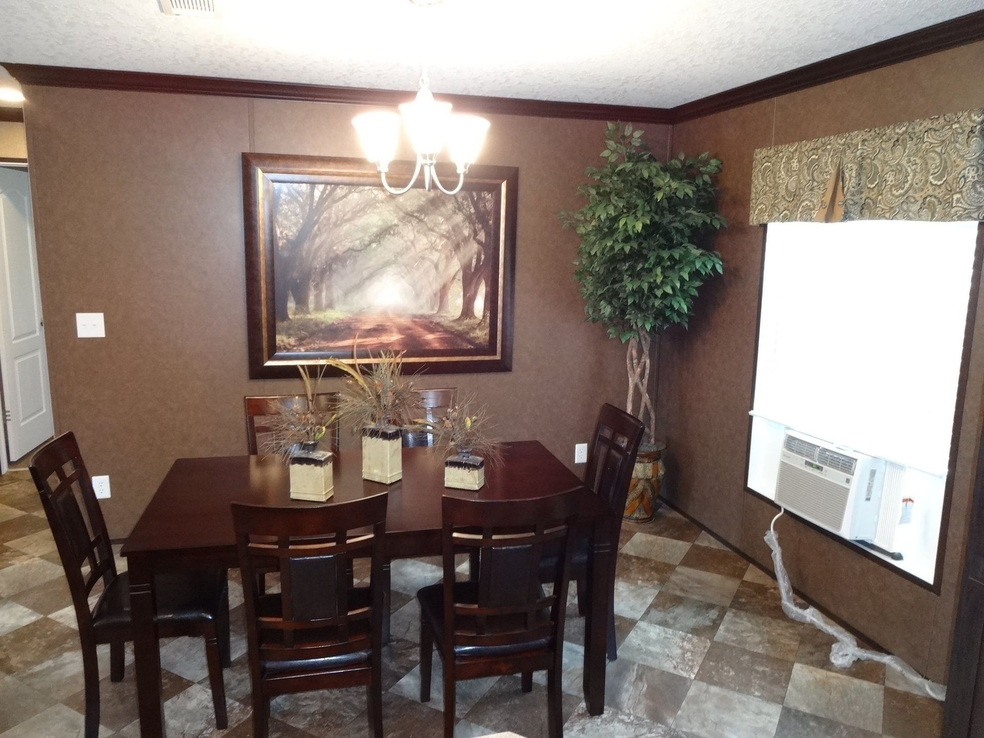 Dining room with dark wood furniture, brown walls, and artwork. A/C unit visible.