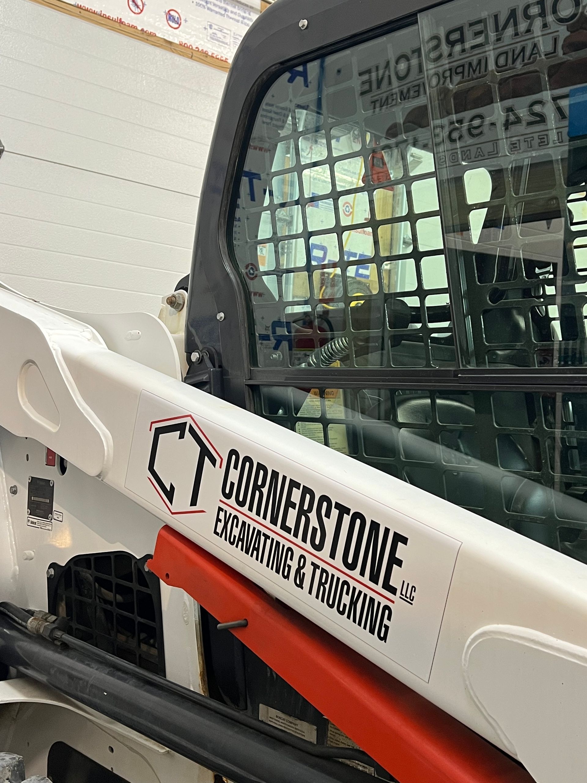 A white tractor with a sticker on the side that says cornerstone