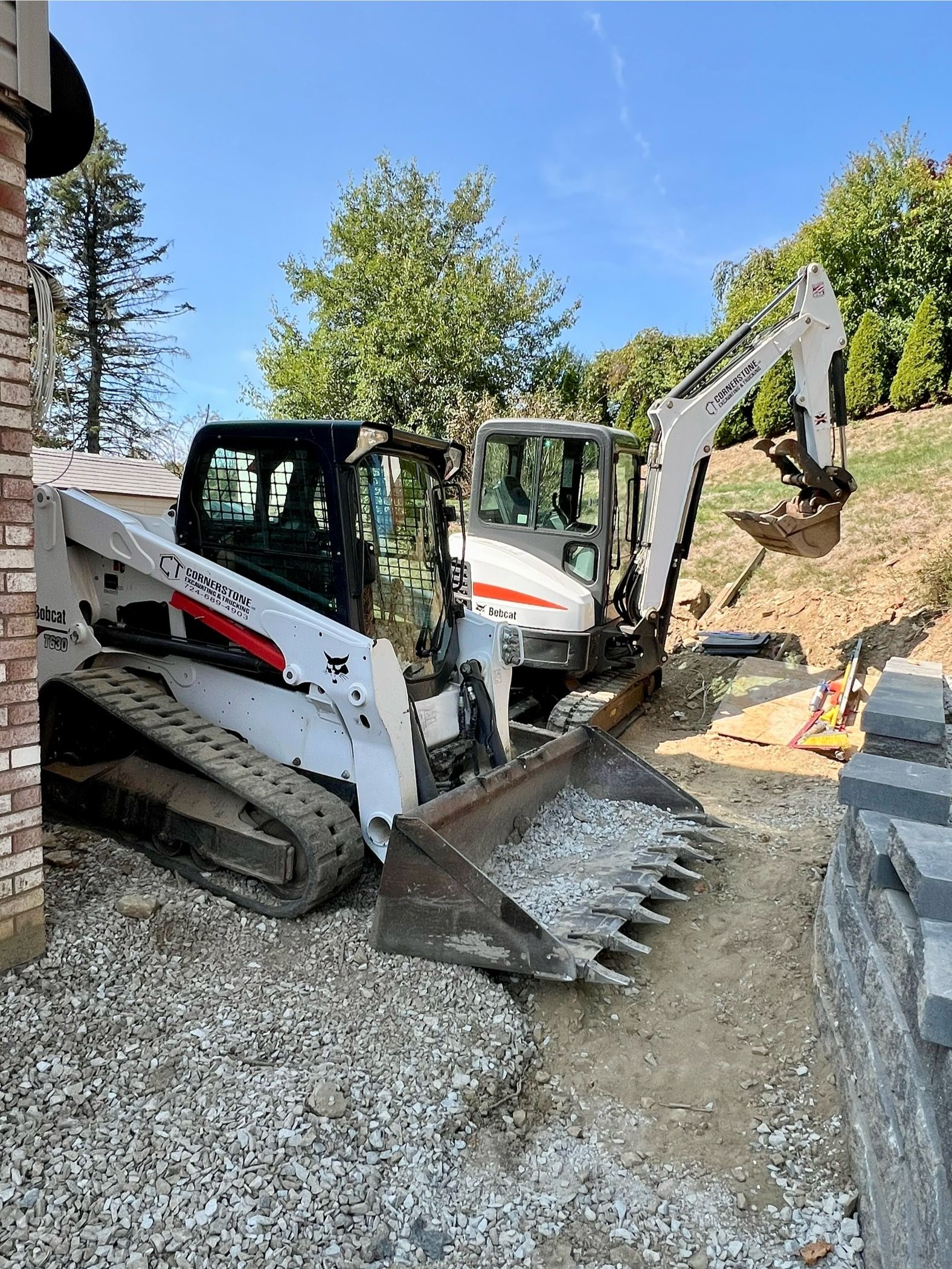 Two bulldozers are parked next to each other on a construction site.