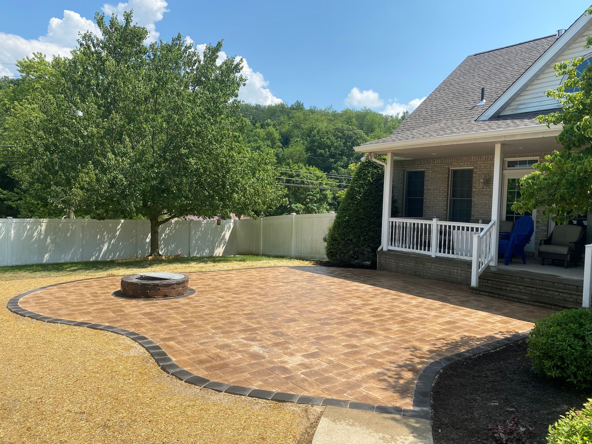 There is a fire pit in the backyard of a house.