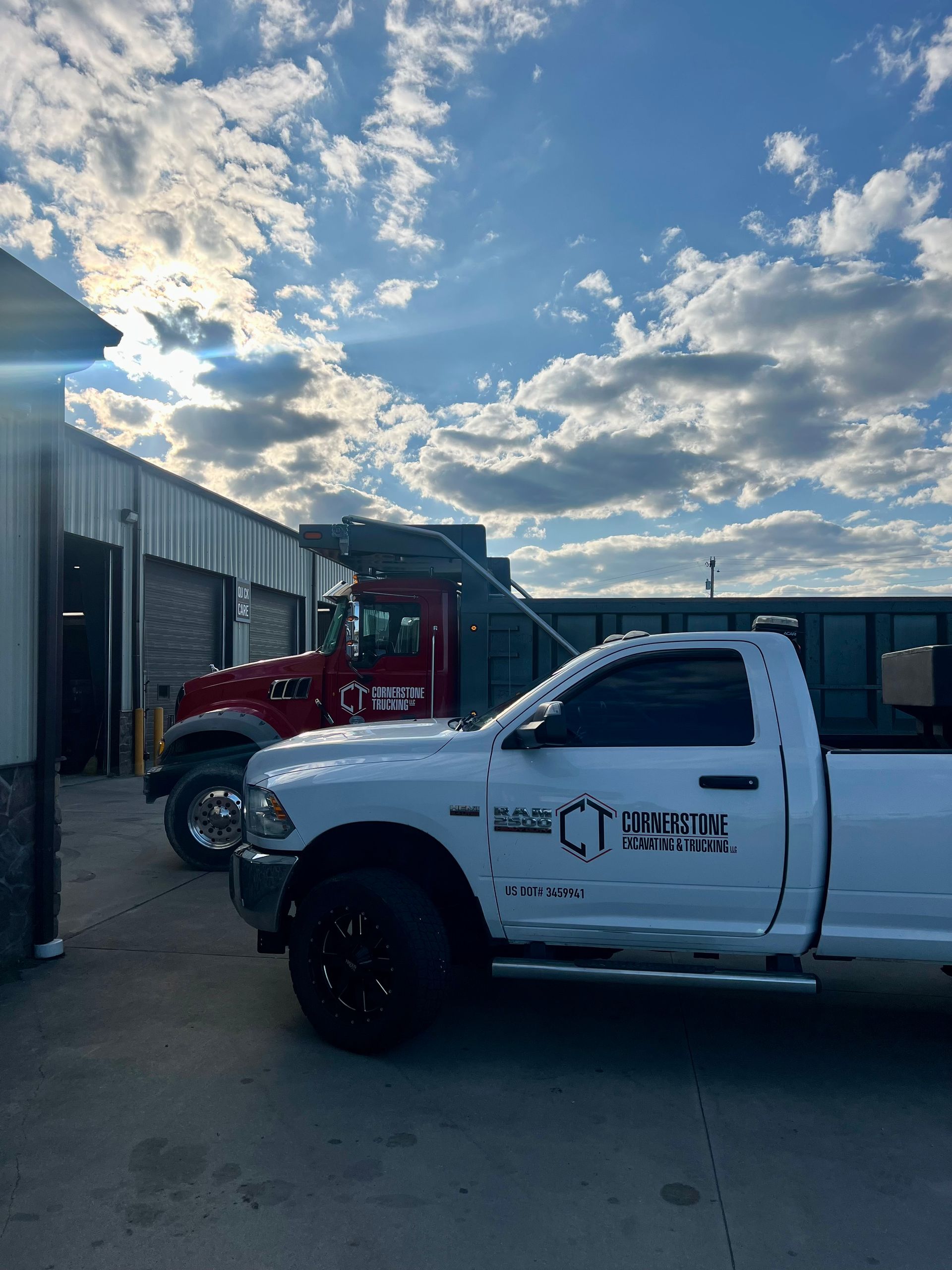 A white truck is parked in front of a building