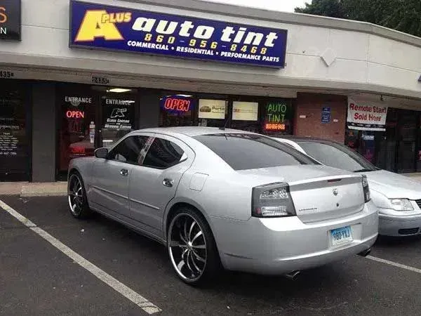 Silver Dodge Charger parked in front of 