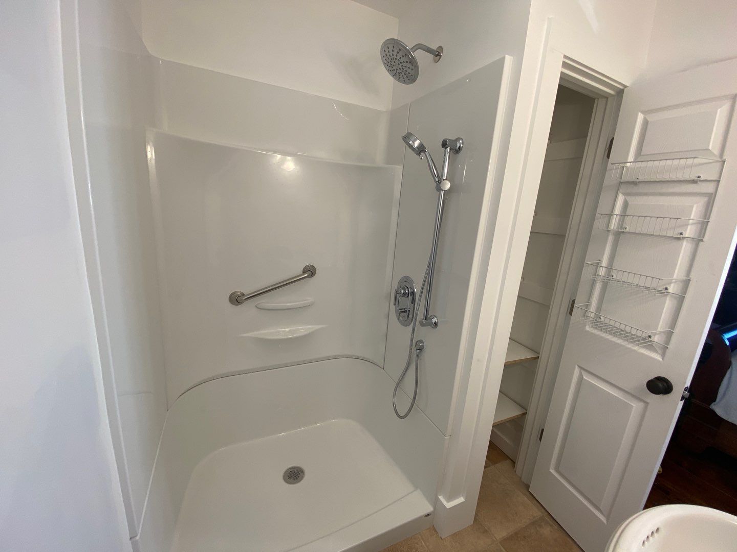 a bathroom with a walk in shower and a sink .