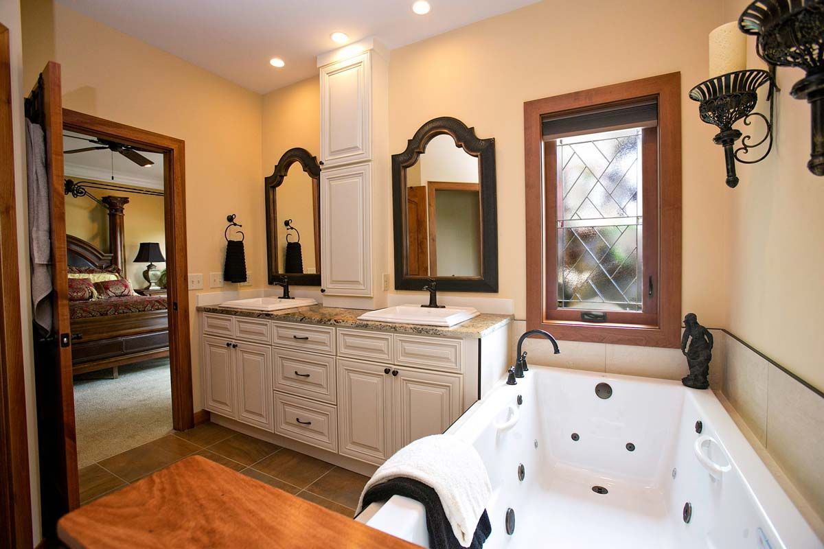 a bathroom with a jacuzzi tub and two sinks