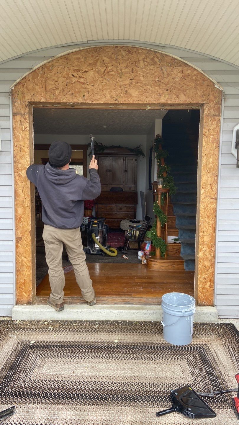 a man is working on a door in a house .
