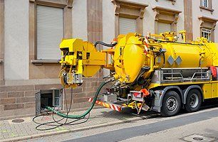 Sewage truck on city street in working process