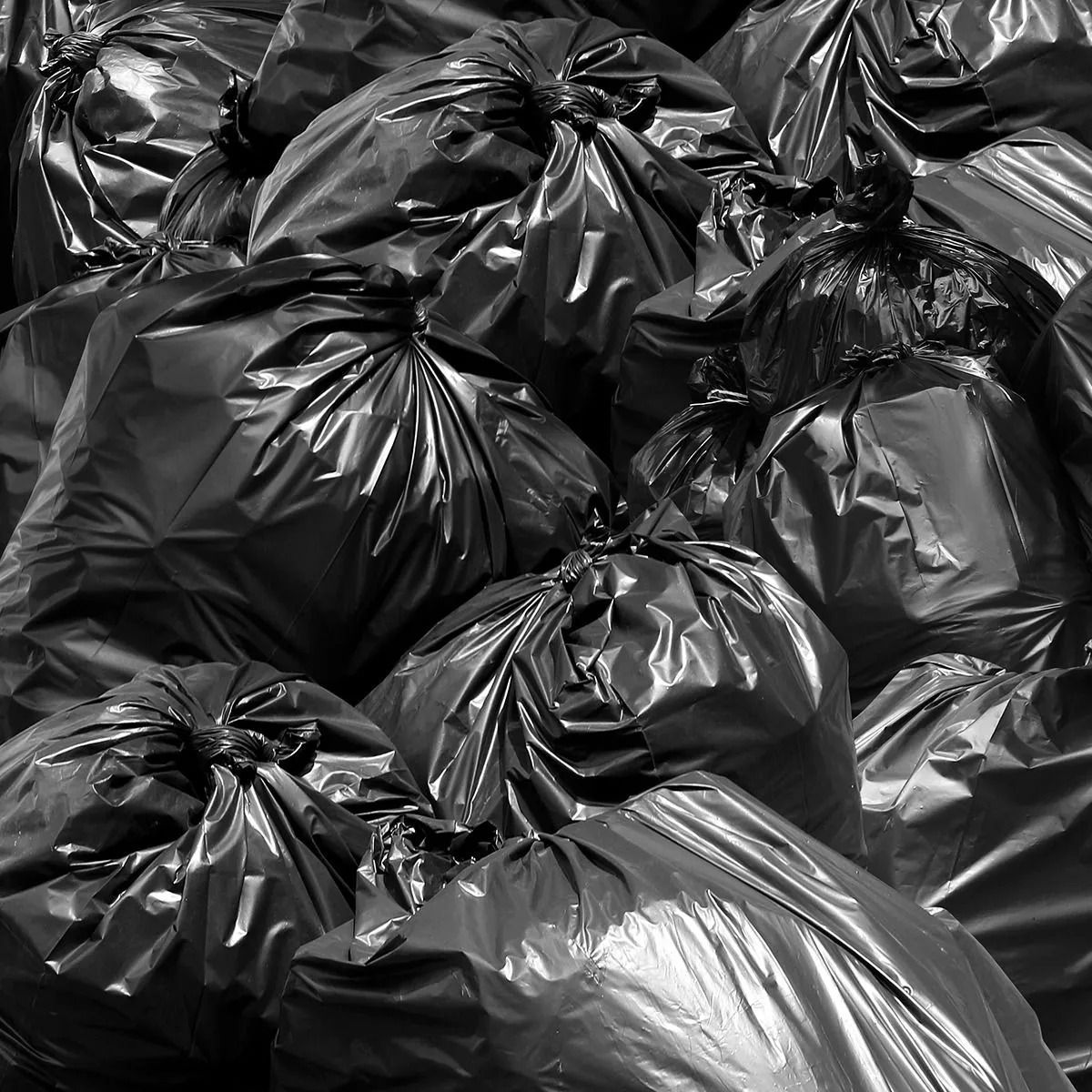 Black plastic garbage bags piled together.