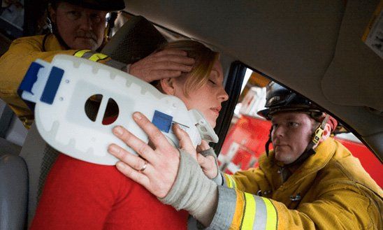 Firefighters helping a woman in an accident