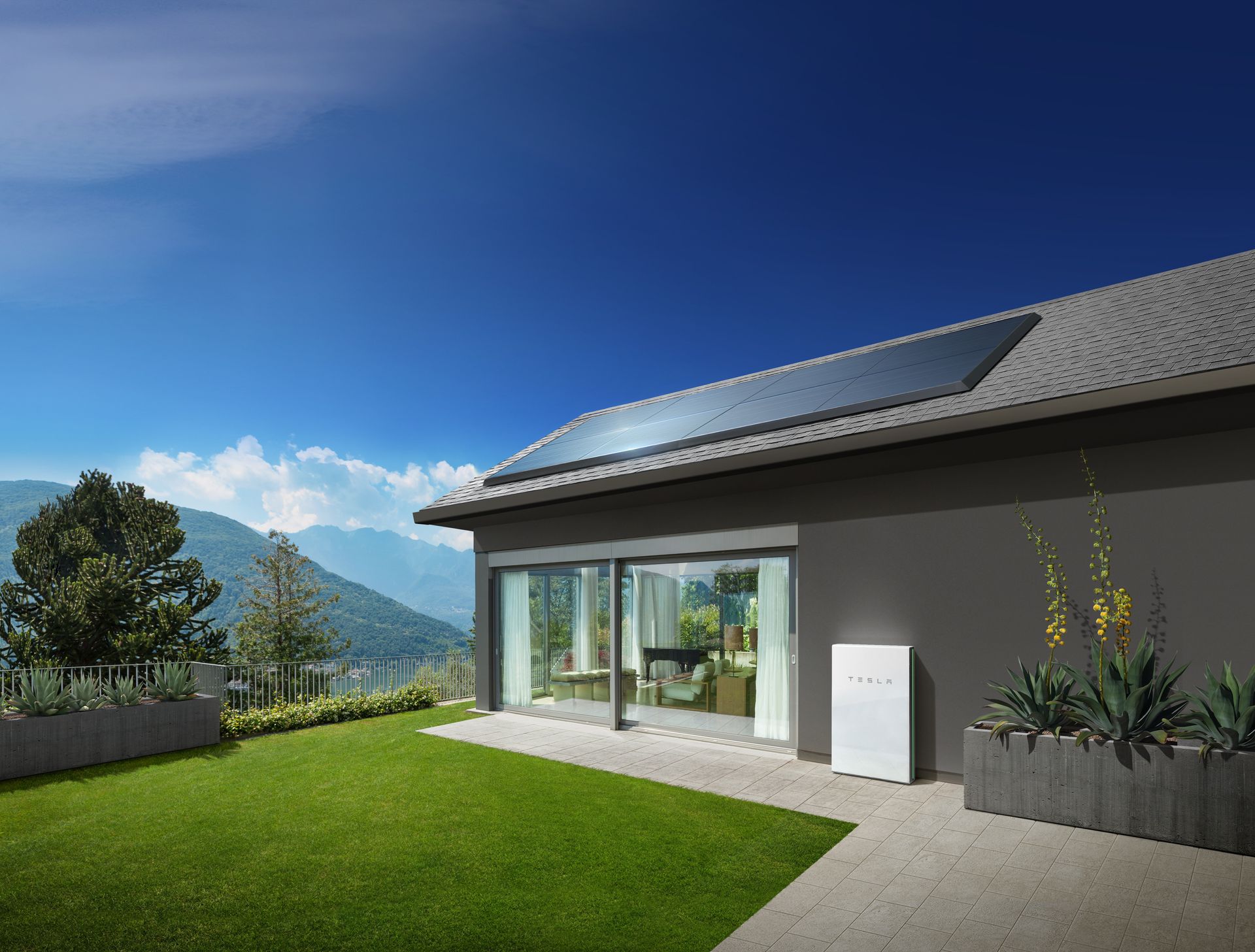 Modern home with rooftop solar panels and a Tesla Powerwall mounted beside a landscaped backyard with mountain views.