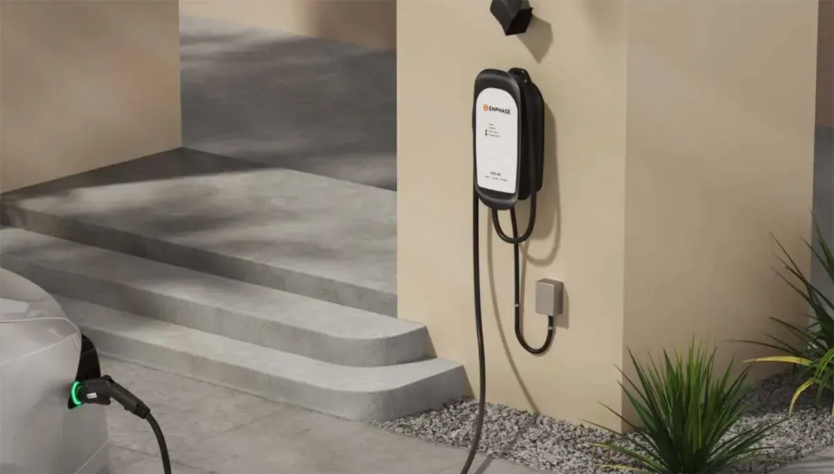 Outdoor stair landing with a wall-mounted EV charging station and a connected cable.