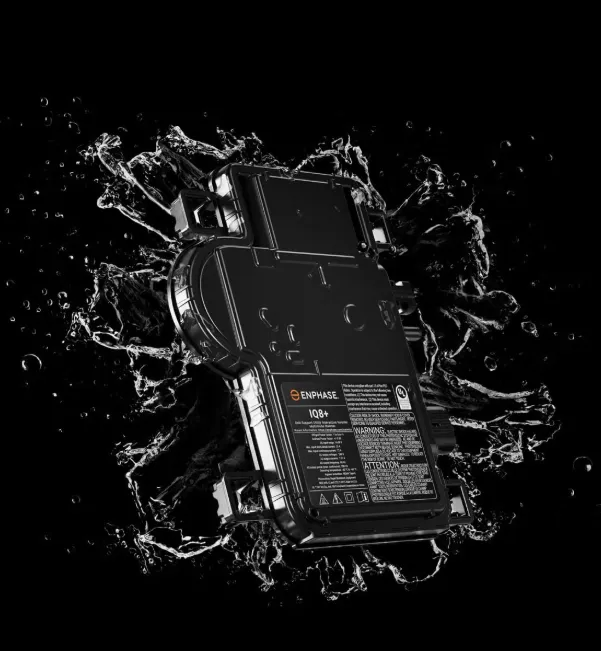 Black rugged electronic device splashing through water on a dark background