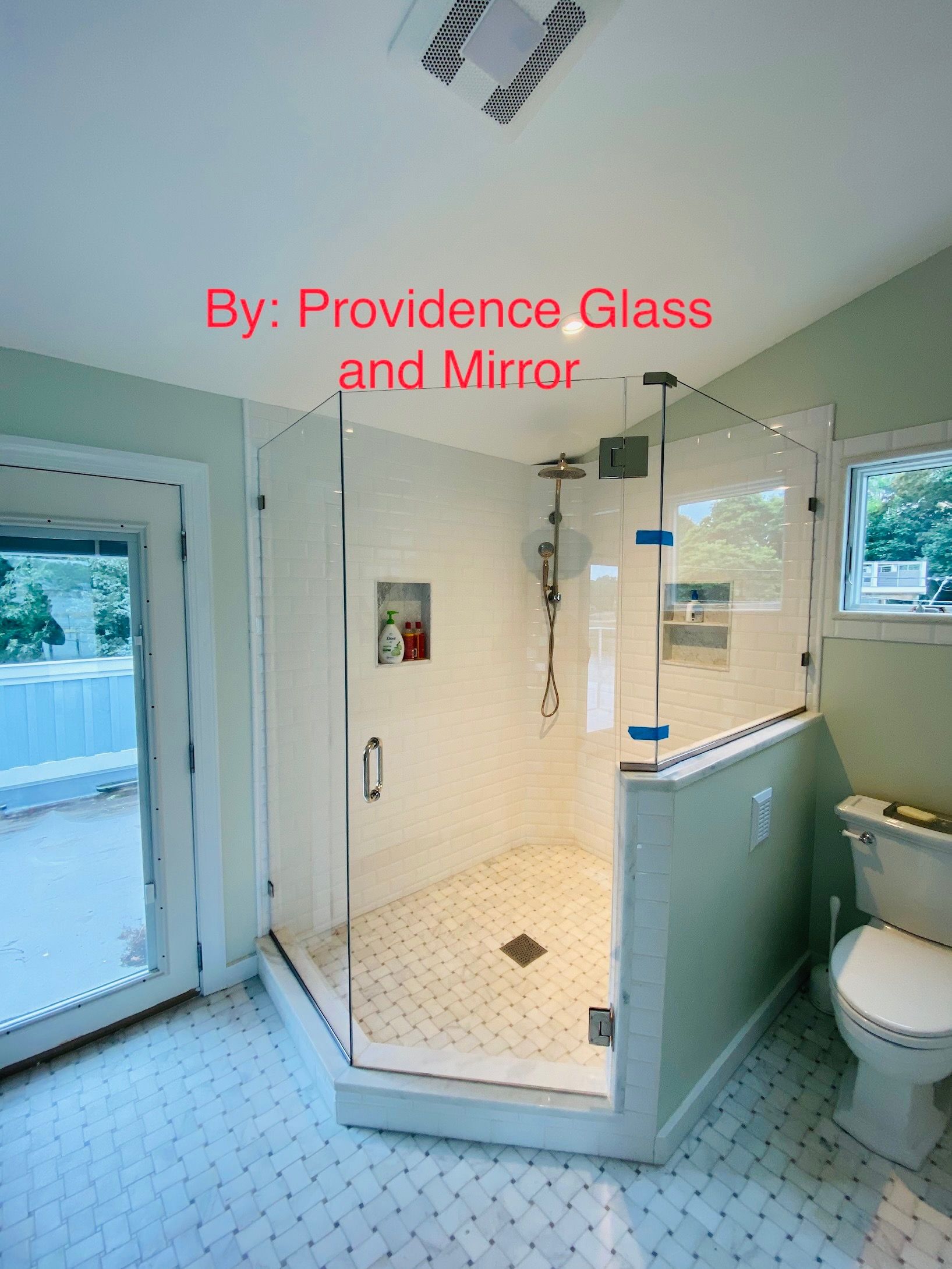 A bathroom with a walk in shower and a toilet.