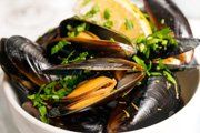 bowl filled with mussels and chopped onion