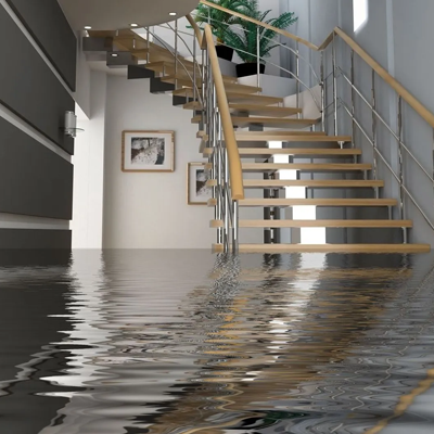 A flooded hallway with stairs leading up to the second floor.