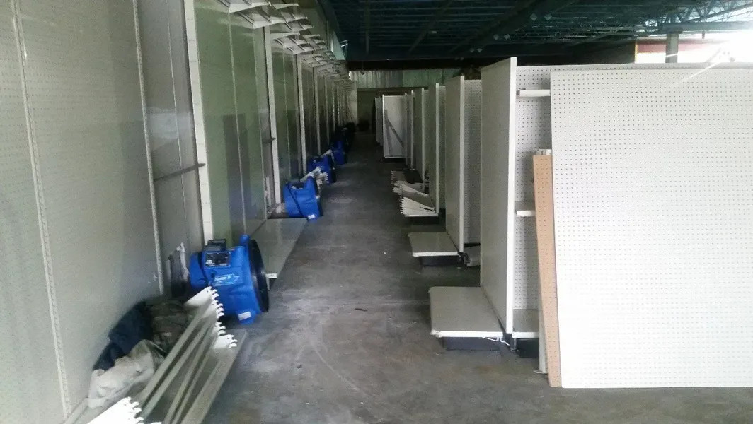 A long hallway with a lot of empty shelves.