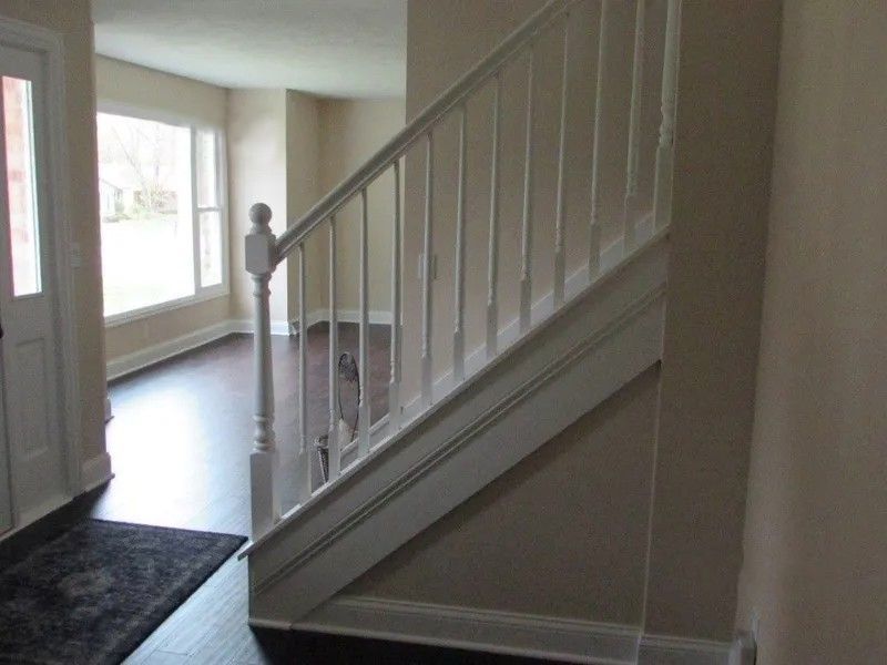 A staircase in a house with a white railing.
