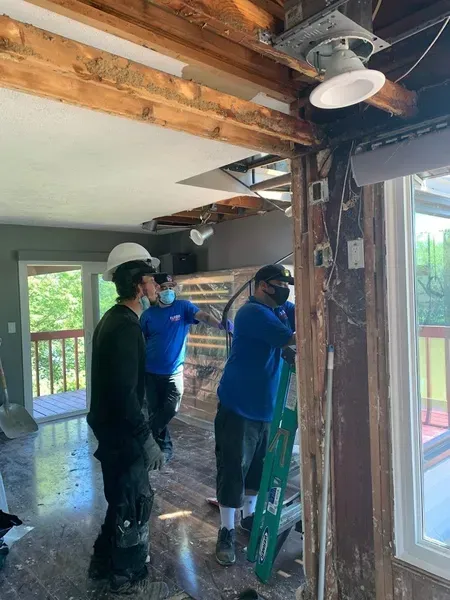 A group of men are working on a house.