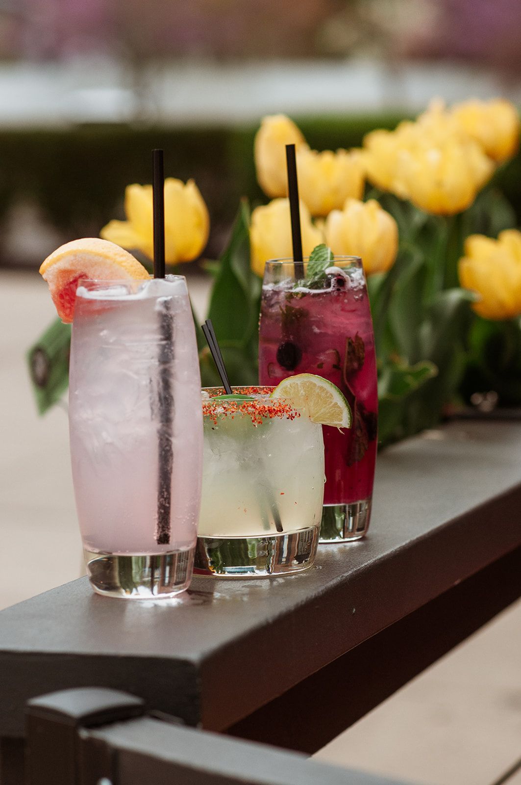 A table with three drinks and a menu on it
