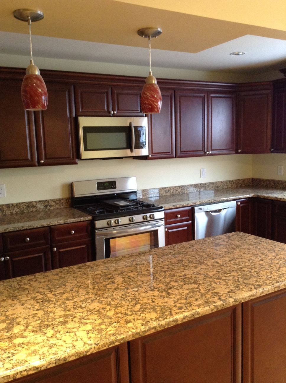 A kitchen with stainless steel appliances and granite counter tops