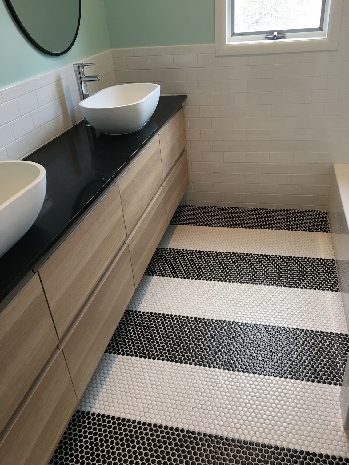 A bathroom with two sinks and a striped floor