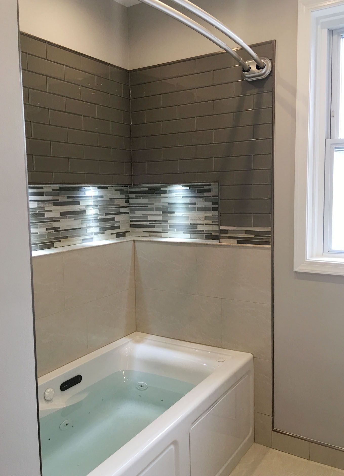 A bathroom with a bathtub and a shower.