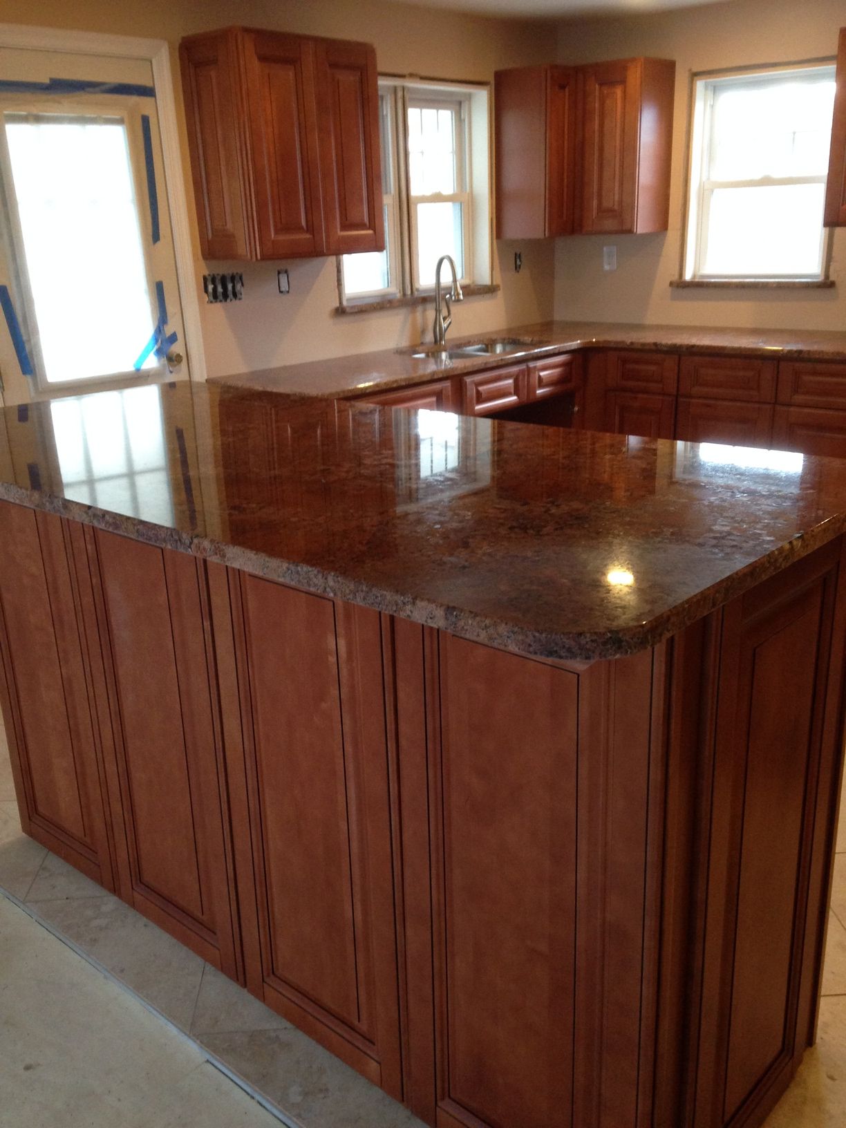 A kitchen with wooden cabinets and granite counter tops