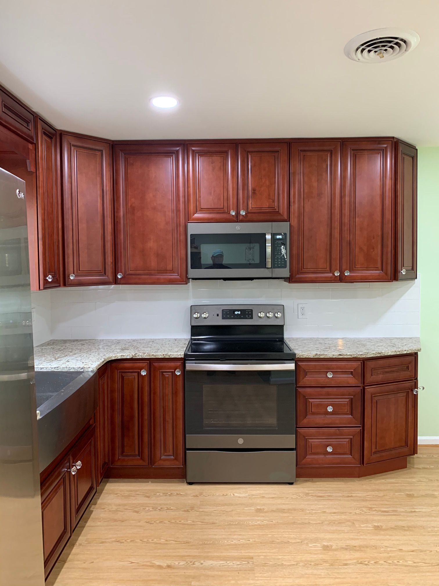 A kitchen with stainless steel appliances and wooden cabinets.