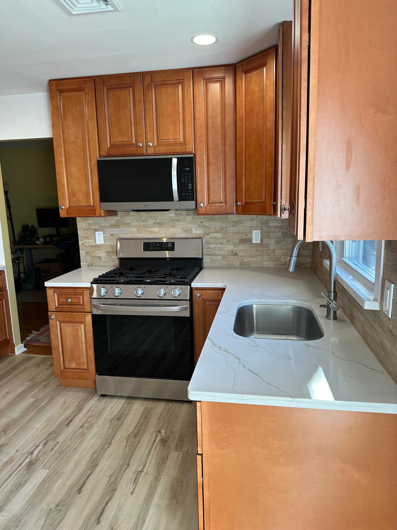 A kitchen with stainless steel appliances and wooden cabinets