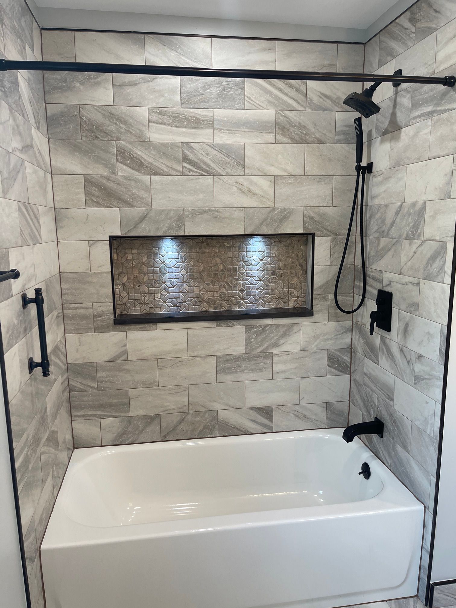 A bathroom with a bathtub and a shower.