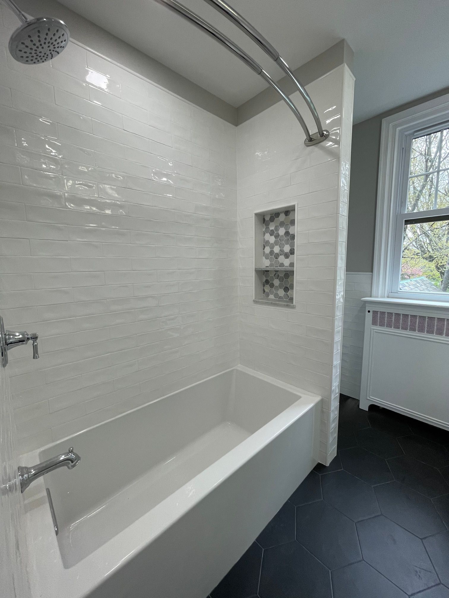 A bathroom with a bathtub and a shower.