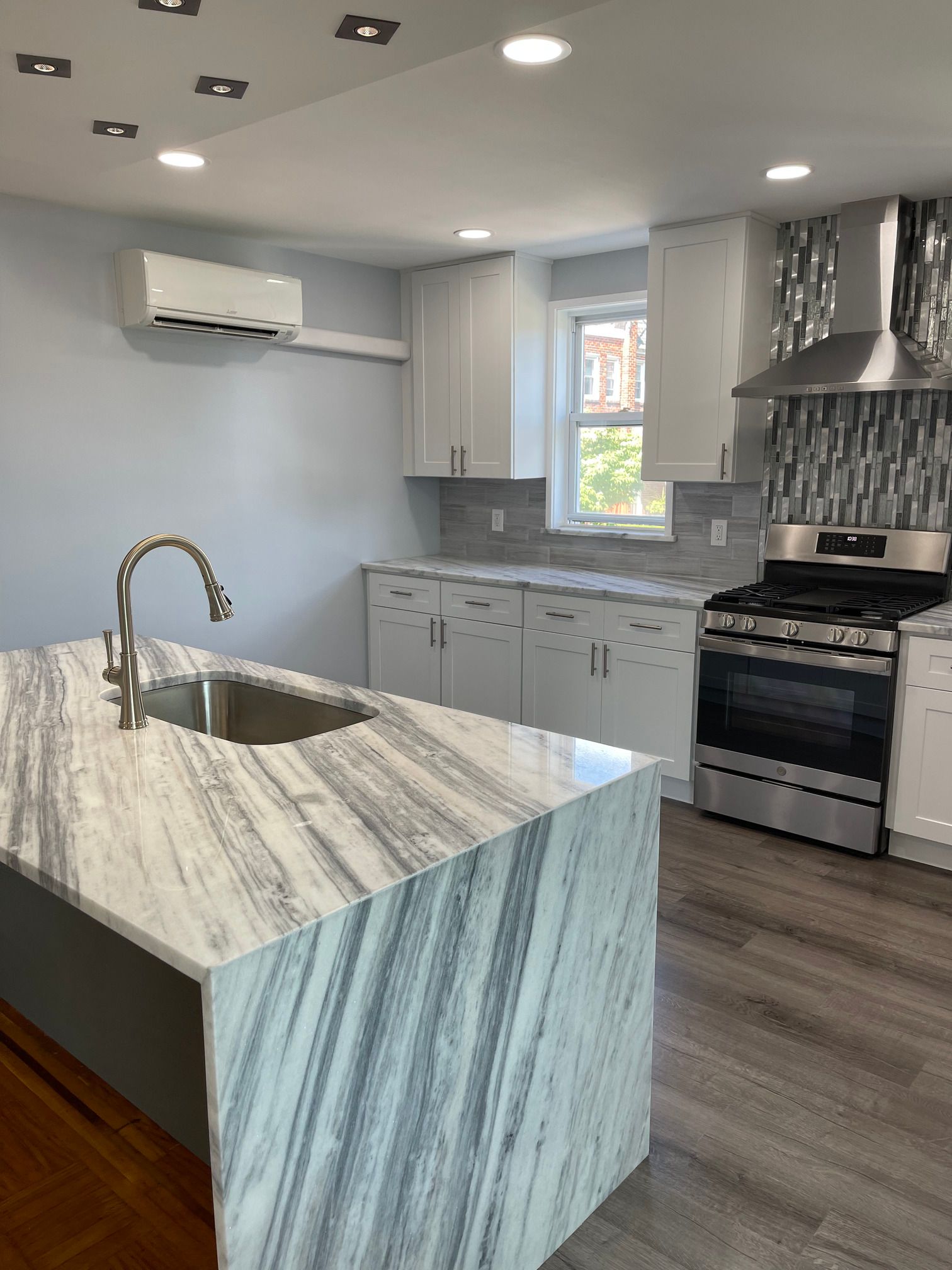 A kitchen with a large island and a sink