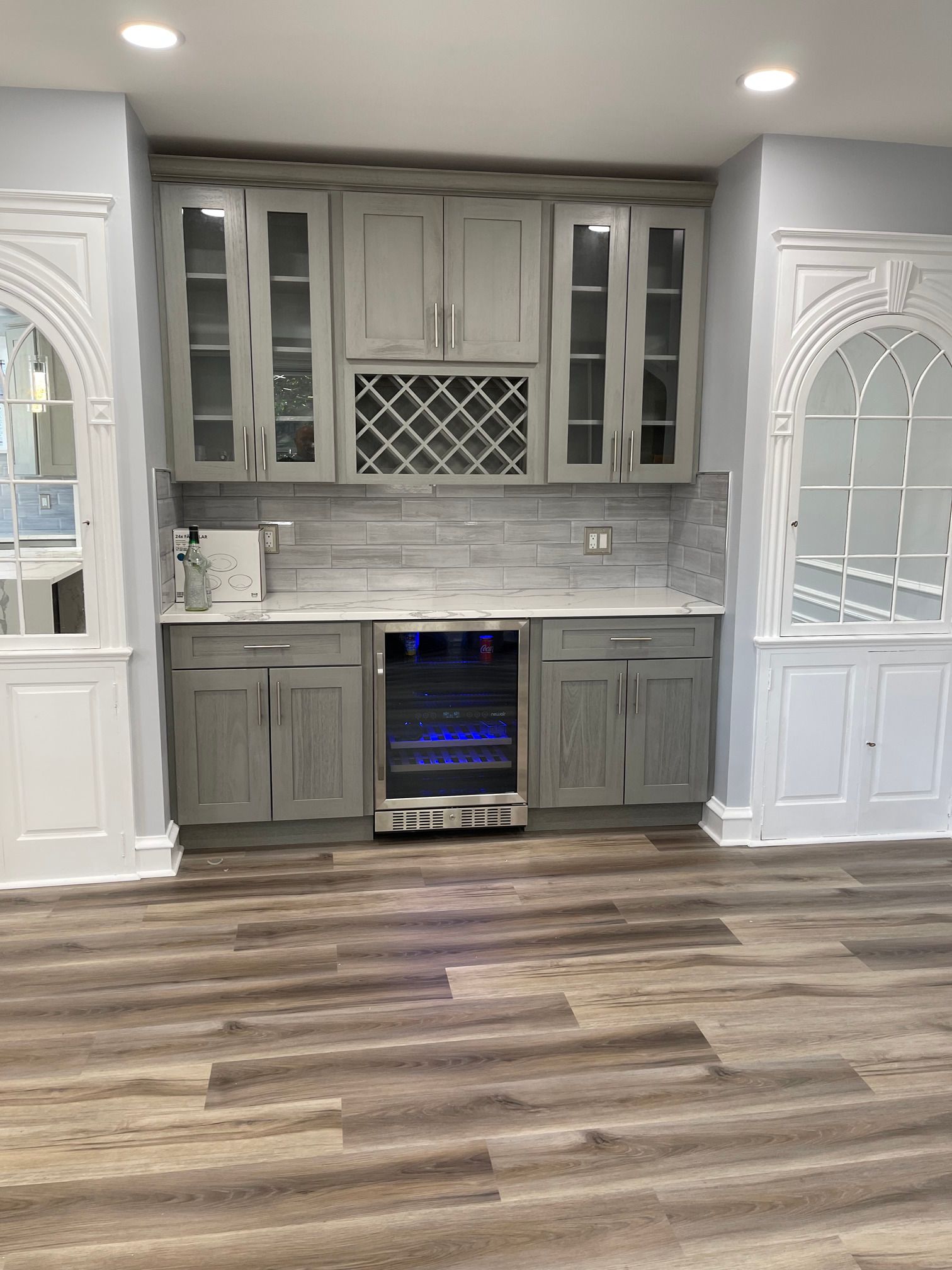 There is a wine cooler in the middle of the kitchen.